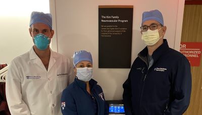 Neurosurgery Team standing in front of new Kim Family Plaque outside of OR.